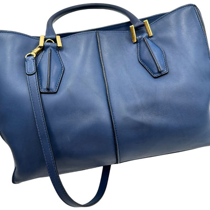 Bauletto Tod's in pelle blu con parti metalliche dorate; munita di doppi manici stondati e una tracolla amovibile e regolabile 