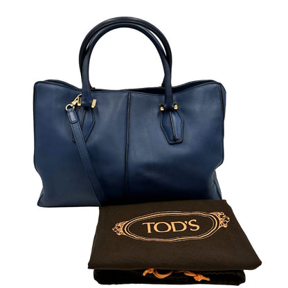 dustbag Bauletto Tod's in pelle blu con parti metalliche dorate; munita di doppi manici stondati e una tracolla amovibile e regolabile 