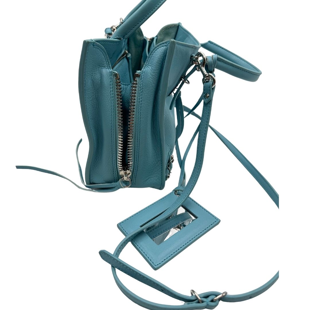 lato  Borsa Balenciaga in pelle color turchese con parti metalliche argentate; munita di doppi manici stondati e una tracolla amovibile e regolabile. Completa di dustbag e cartellini, di lusso, originale. 