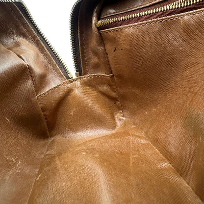  trousse in canvas marrone monogram con finiture in vacchetta naturale e parti metalliche dorate.