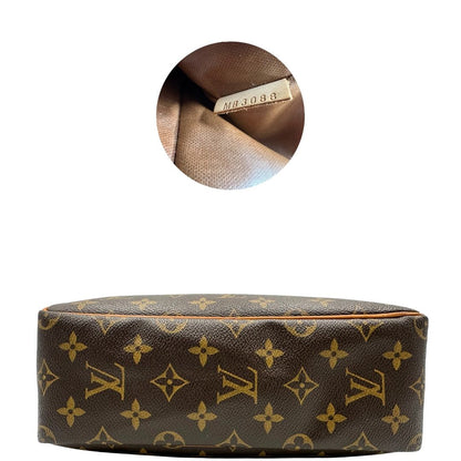  trousse in canvas marrone monogram con finiture in vacchetta naturale e parti metalliche dorate.