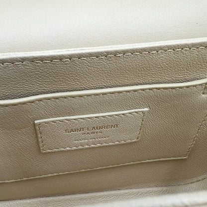 interno Borsa Saint Laurent in pelle nabuk beige e pelle lucida nera con parti metalliche dorate, impreziosita da iconico logo Cassandre sul front; munita di un manico regolabile. Completa di corredo. 