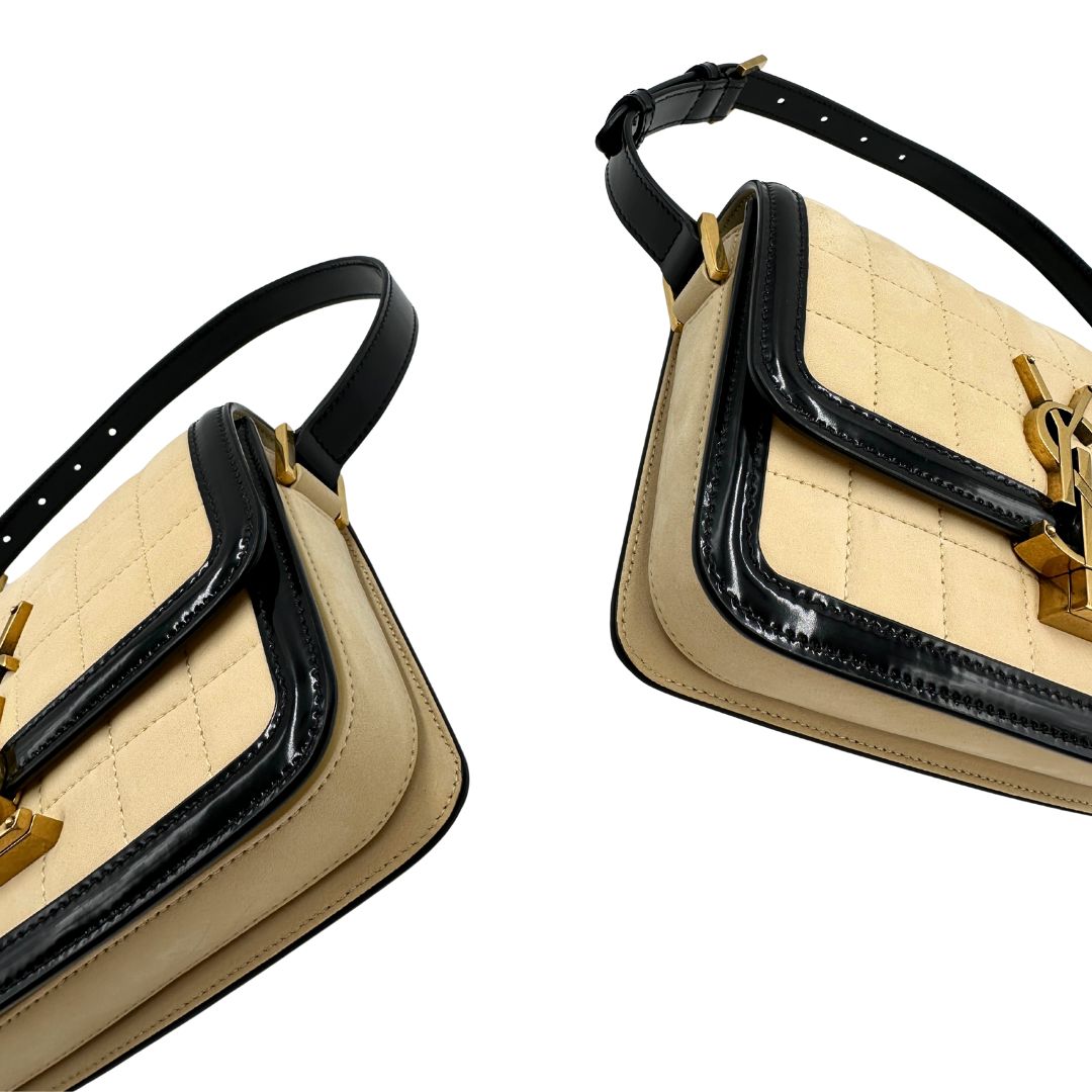 angoli Borsa Saint Laurent in pelle nabuk beige e pelle lucida nera con parti metalliche dorate, impreziosita da iconico logo Cassandre sul front; munita di un manico regolabile. Completa di corredo.