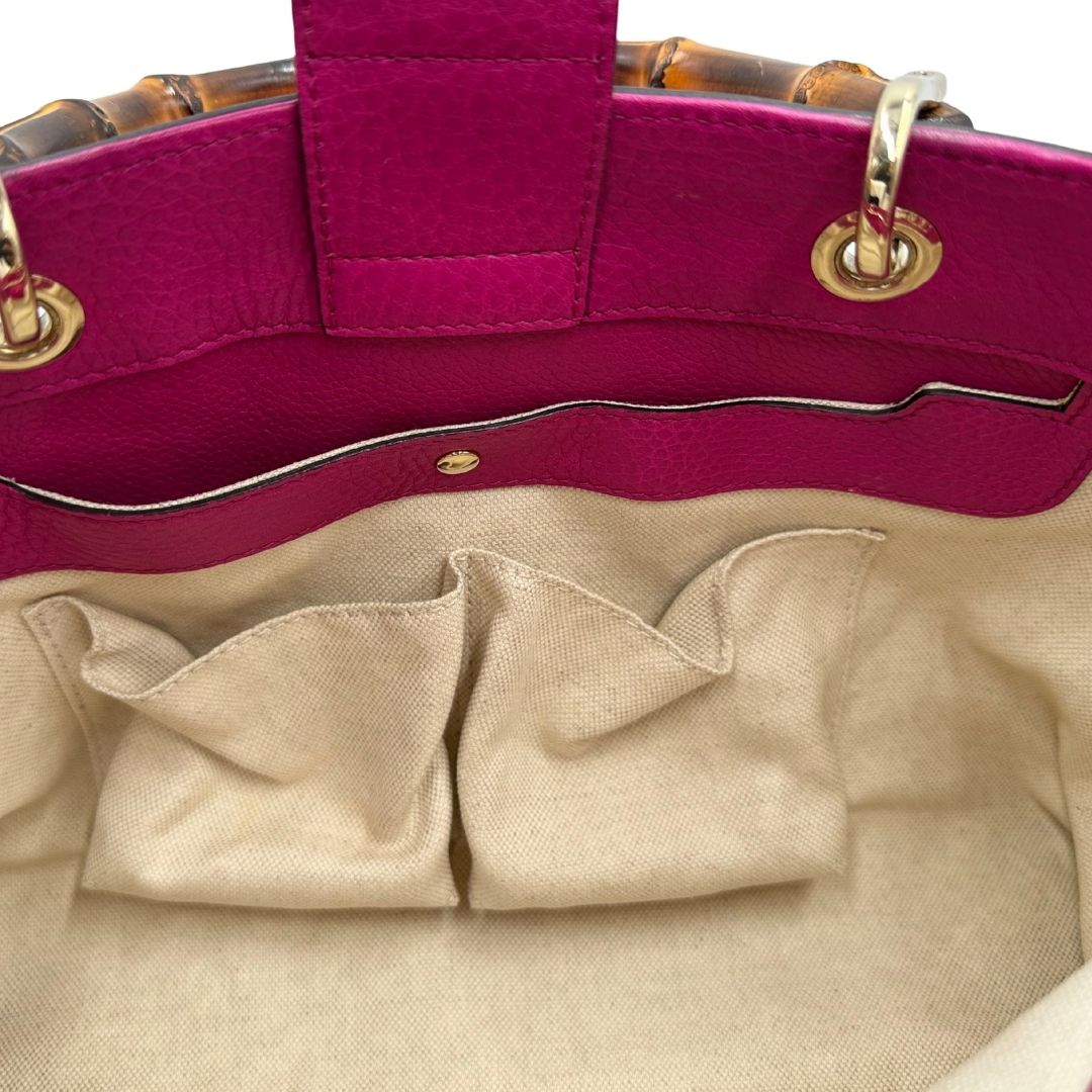 interno Borsa Gucci in pelle martellata fucsia con parti metalliche dorate; munita di doppi manici in bamboo e una tracolla amovibile e regolabile, di lusso, ottime condizioni, usata. 