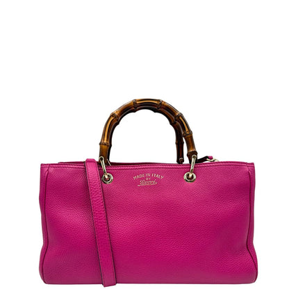 front Borsa Gucci in pelle martellata fucsia con parti metalliche dorate; munita di doppi manici in bamboo e una tracolla amovibile e regolabile, di lusso, ottime condizioni, usata. 