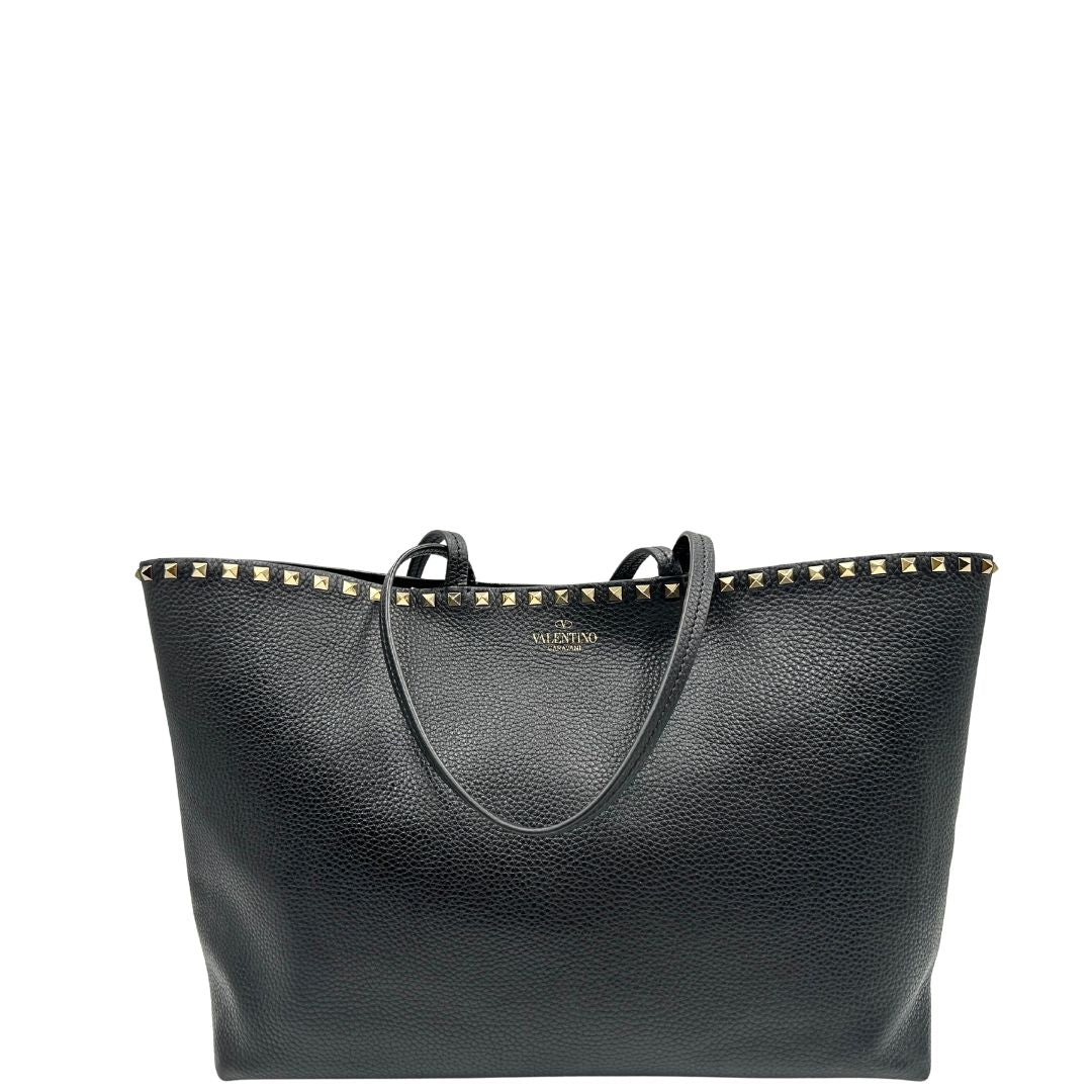 Borsa Valentino Garavani in pelle nera con parti metalliche dorate, impreziosita da borchie piramidali sulle finiture superiori; munita di doppi manici, di lusso, originale, ottimo stato.