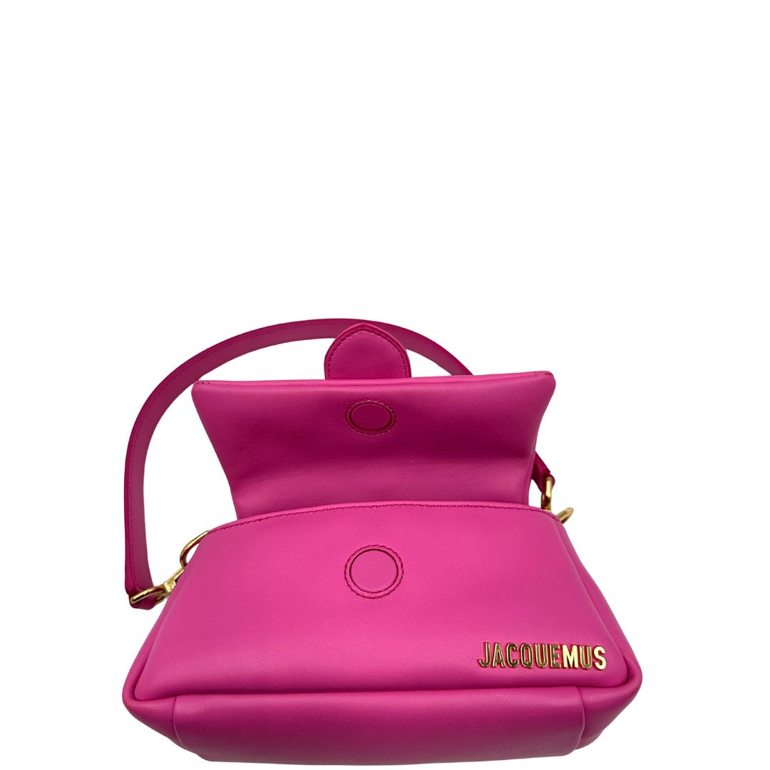 interno Borsa Jacquemus in pelle color neon pink con parti metalliche dorate; munita di un manico singolo e una tracolla, entrambe amovibili. Completa di dustbag, di lusso, originale, ottime condizioni. 