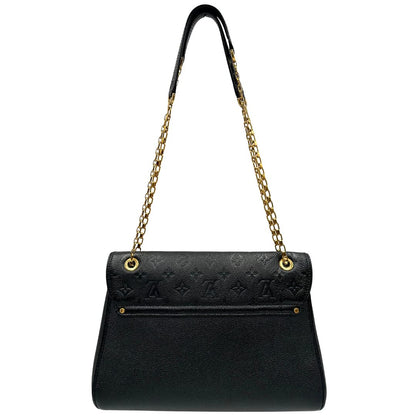 retro Borsa Louis Vuitton in pelle nera monogram Empreinte con parti metalliche dorate; munita di una tracolla scorrevole in catena con spallaccio in pelle, di lusso, originale, ottime condizioni. 