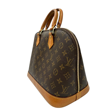 lato Borsa Louis Vuitton in canvas marrone monogram con finiture in vacchetta naturale e parti metalliche dorate; munita di doppi manici stondati, da portare a mano. Completa di chiavi e lucchetto, di lusso, originale, ottime condizioni. 