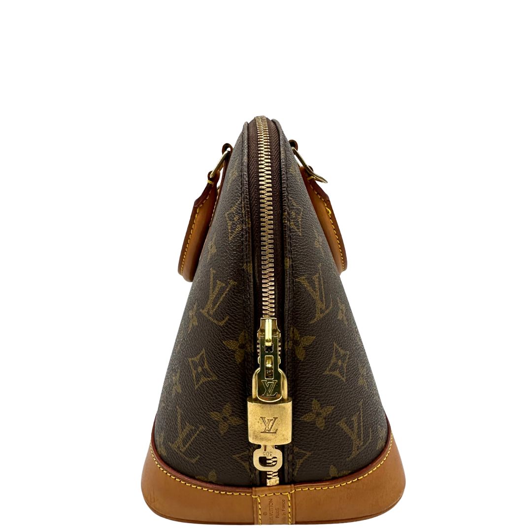 lato Borsa Louis Vuitton in canvas marrone monogram con finiture in vacchetta naturale e parti metalliche dorate; munita di doppi manici stondati, da portare a mano. Completa di chiavi e lucchetto, di lusso, originale, ottime condizioni.
