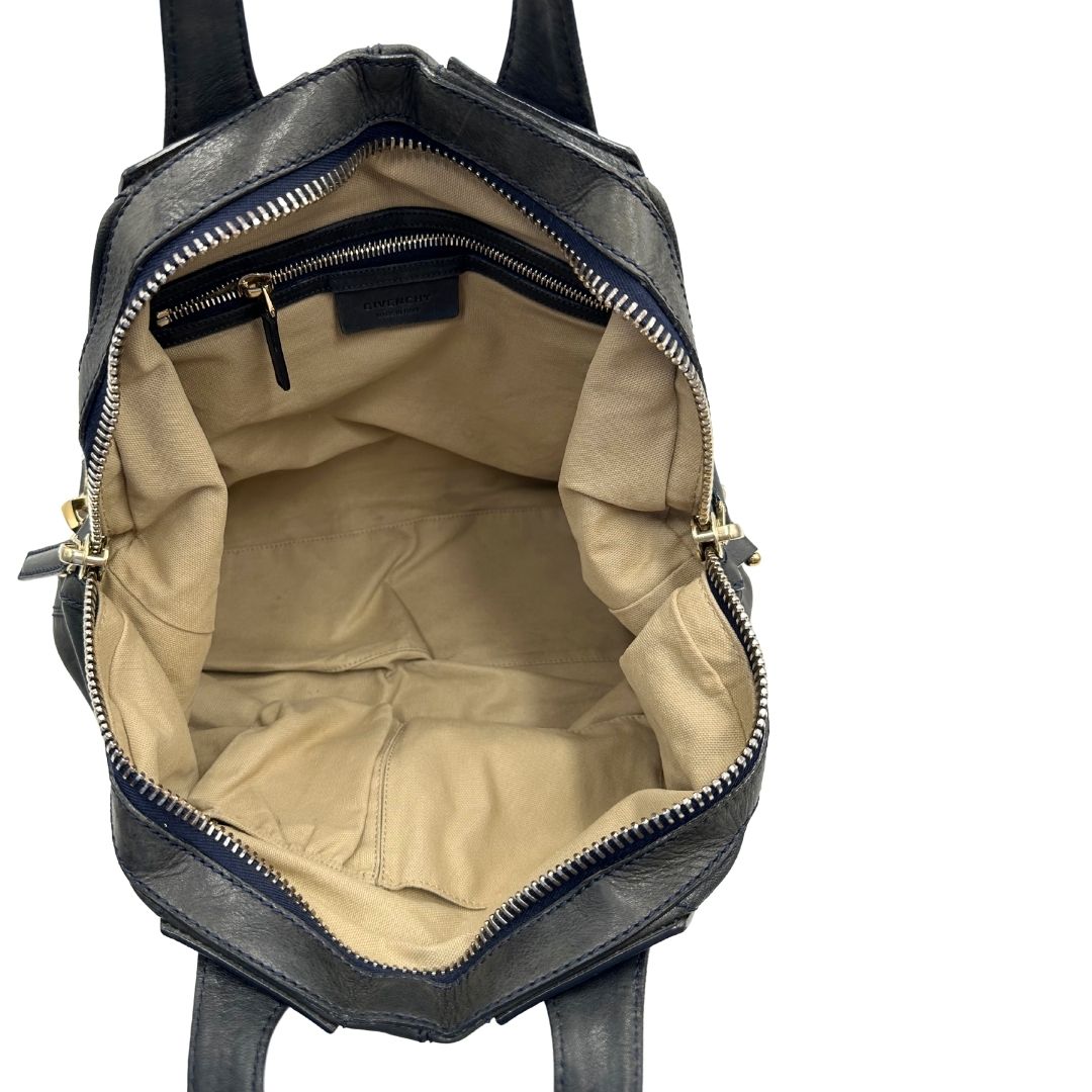 Interno Borsa Givenchy Nightingale in pelle blu notte e parti metalliche dorate. Munita di doppi manici e tracolla una amovibile arricchita da una cerniera decorativa. Indossabile a mano o a tracolla. Originale, usata, di lusso, in ottime condizioni