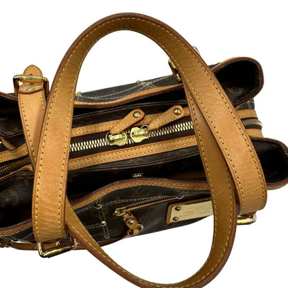 Vista superiore di una borsa Louis Vuitton in canvas marrone monogram con cuciture decorative e finiture in vacchetta naturale. Parti metalliche dorate; munita di doppi manici, indossabile a spalla.