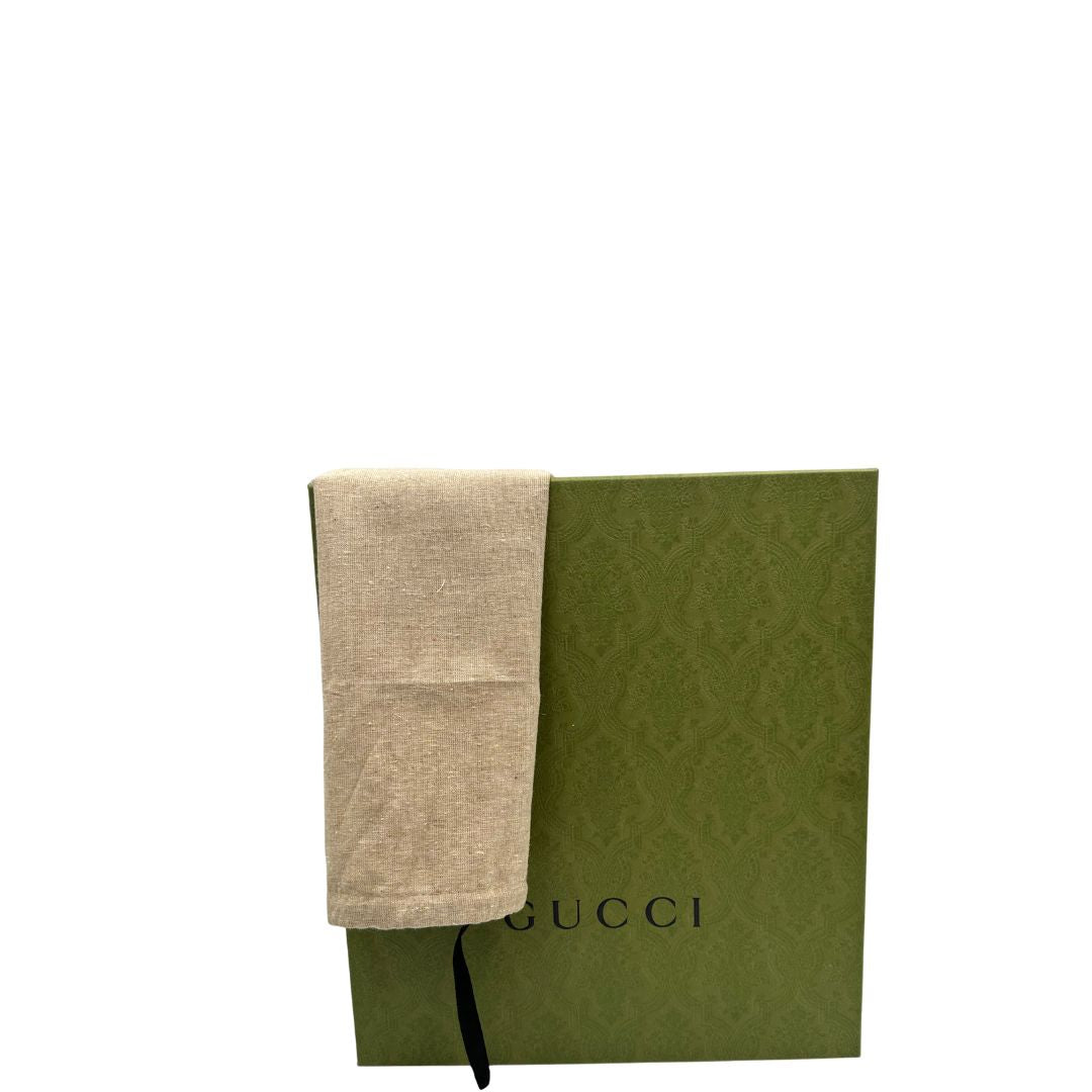 Stivaletti Gucci in pelle nera con inserti metallici dorati, zirconi e logo GG in metallo