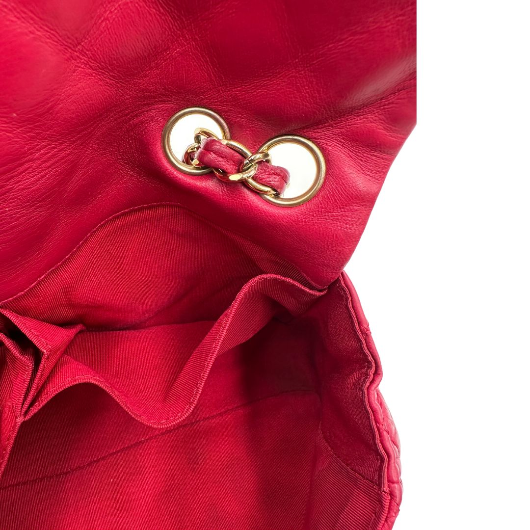 Tasca interna di una Borsa Chanel Gabrielle in pelle matelassé color fucsia con parti metalliche dorate; impreziosita da charm con cuoricini sulla tracolla intrecciata in catena e pelle. Completa di scatola e card di autenticità. Originale, usata, di lusso in ottime condizion