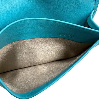 Portafoglio Tod's in pelle color turchese con parti metalliche argentate. Completo di corredo, di lusso, originale, ottime condizioni.