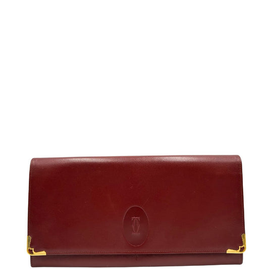 front  Clutch Les Must de Cartier in pelle bordeaux con parti metalliche dorate. Munito di scatola, di lusso, originale. 