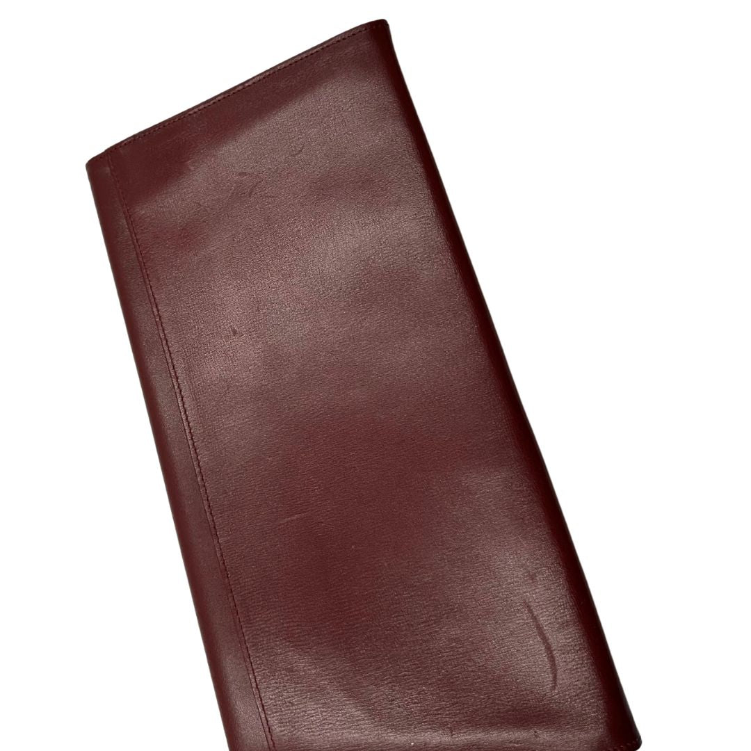 interni  Clutch Les Must de Cartier in pelle bordeaux con parti metalliche dorate. Munito di scatola, di lusso, originale.