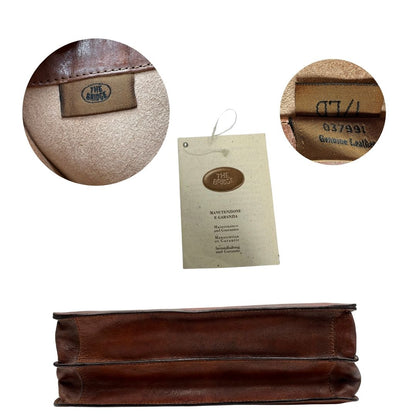 base  Cartella The Bridge in cuoio marrone con parti metalliche oro anticato; dotata di manico, una tracolla regolabile e amovibile e una clochette portachiavi, di lusso, originale, ottime condizioni, usata. 