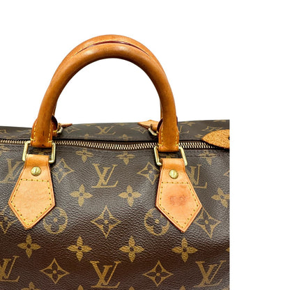 Manici di una Borsa Louis Vuitton in canvas marrone monogram con finiture in vacchetta naturale e parti metalliche dorate; munita di doppi manici stondati. Originale, usato, di lusso, in ottime condizioni.
