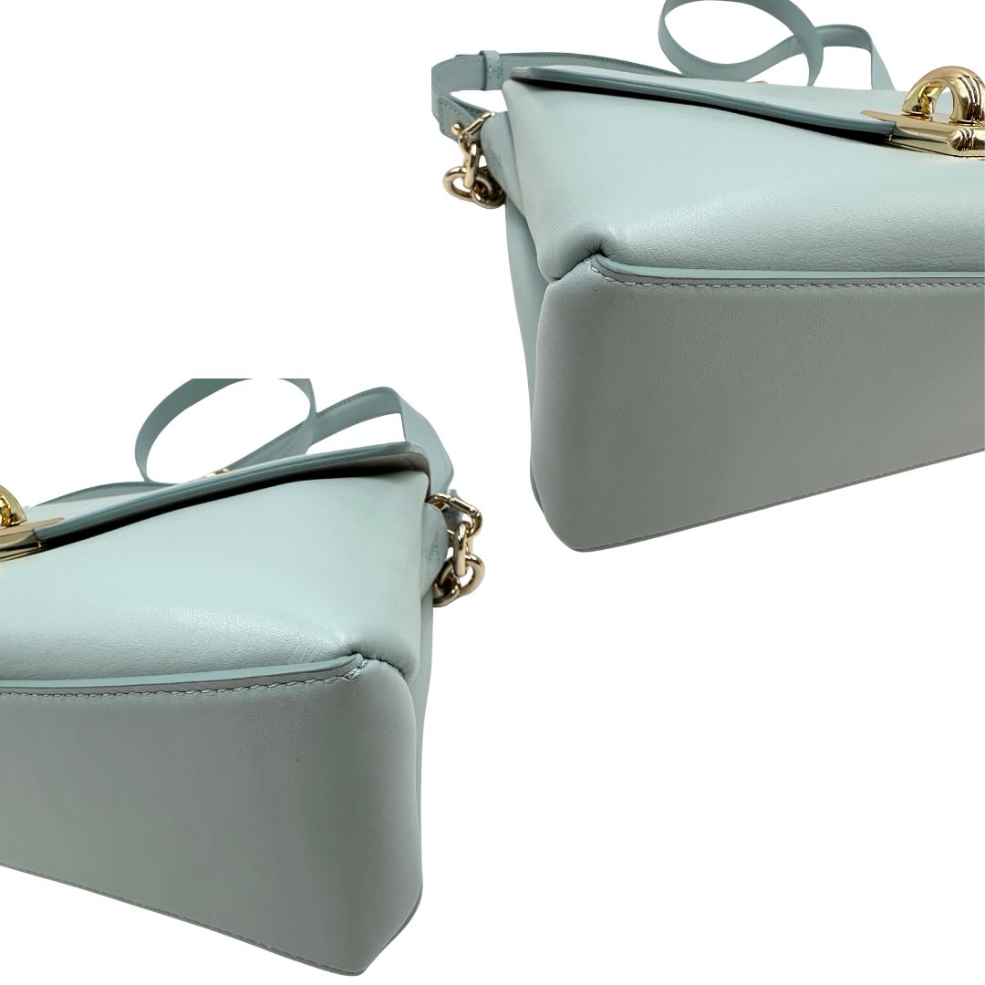 angoli Borsa Furla in pelle celeste con parti metalliche dorate; munita di un manico in catena e una tracolla regolabile. Completa di dustbag, di lusso, usata. 