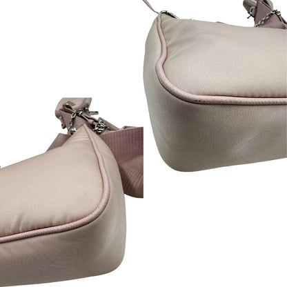 angoli Borsa Prada in nylon rosa con parti metalliche argentate e finiture in pelle tono su tono; munita di un mini pouch amovibile, un accessorio portachiavi, manico in catena e una tracolla in tessuto amovibile e regolabile, di lusso, originale, ottime condizioni. 
