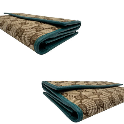 Portafoglio Gucci in tessuto GG con finiture in pelle color turchese. Completo di sacchetto antipolvere, di lusso, originale, ottime condizioni.