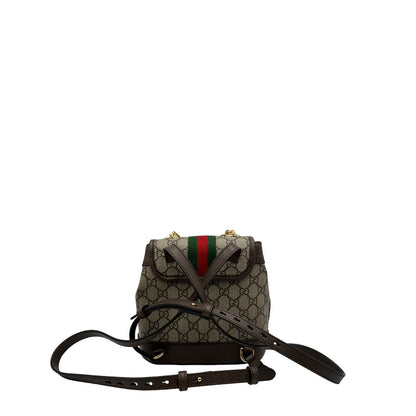 Retro di uno zaino Gucci in canvas beige GG con finiture in pelle marroni e parti metalliche dorate. Iconica striscia Web in verde/rosso sulla patta, impreziosita da un manico in catena amovibile e cinghie in pelle regolabili. Completo di dustbag.