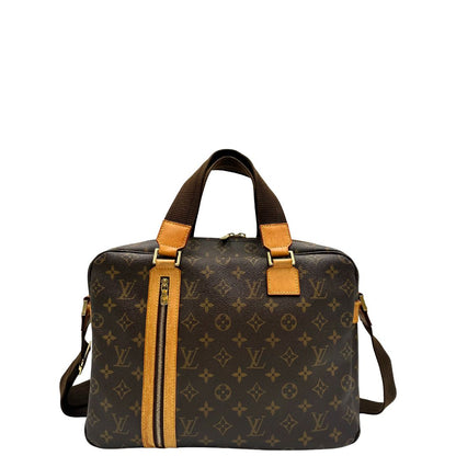 Front di una Borsa Louis Vuitton in canvas marrone monogram con finiture in vacchetta naturale e parti metalliche dorate; munita di due manici e una tracolla in tessuto regolabile. Completa di dustbag. Originale, usata, di lusso, in ottime condizioni.
