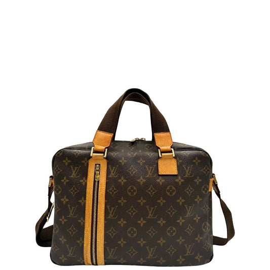 Front di una Borsa Louis Vuitton in canvas marrone monogram con finiture in vacchetta naturale e parti metalliche dorate; munita di due manici e una tracolla in tessuto regolabile. Completa di dustbag. Originale, usata, di lusso, in ottime condizioni.