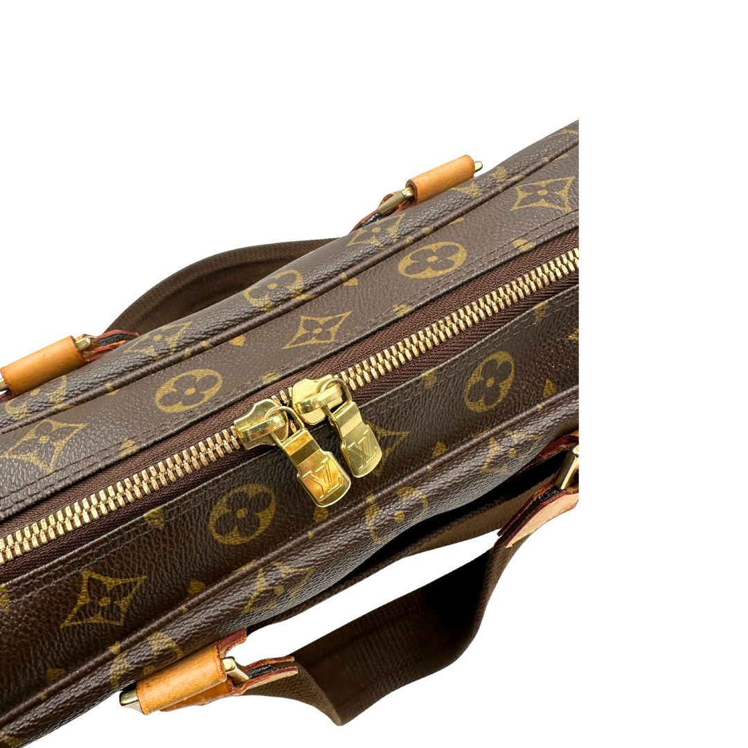 Chiusura di una Borsa Louis Vuitton in canvas marrone monogram con finiture in vacchetta naturale e parti metalliche dorate; munita di due manici e una tracolla in tessuto regolabile. Completa di dustbag. Originale, usata, di lusso, in ottime condizioni.