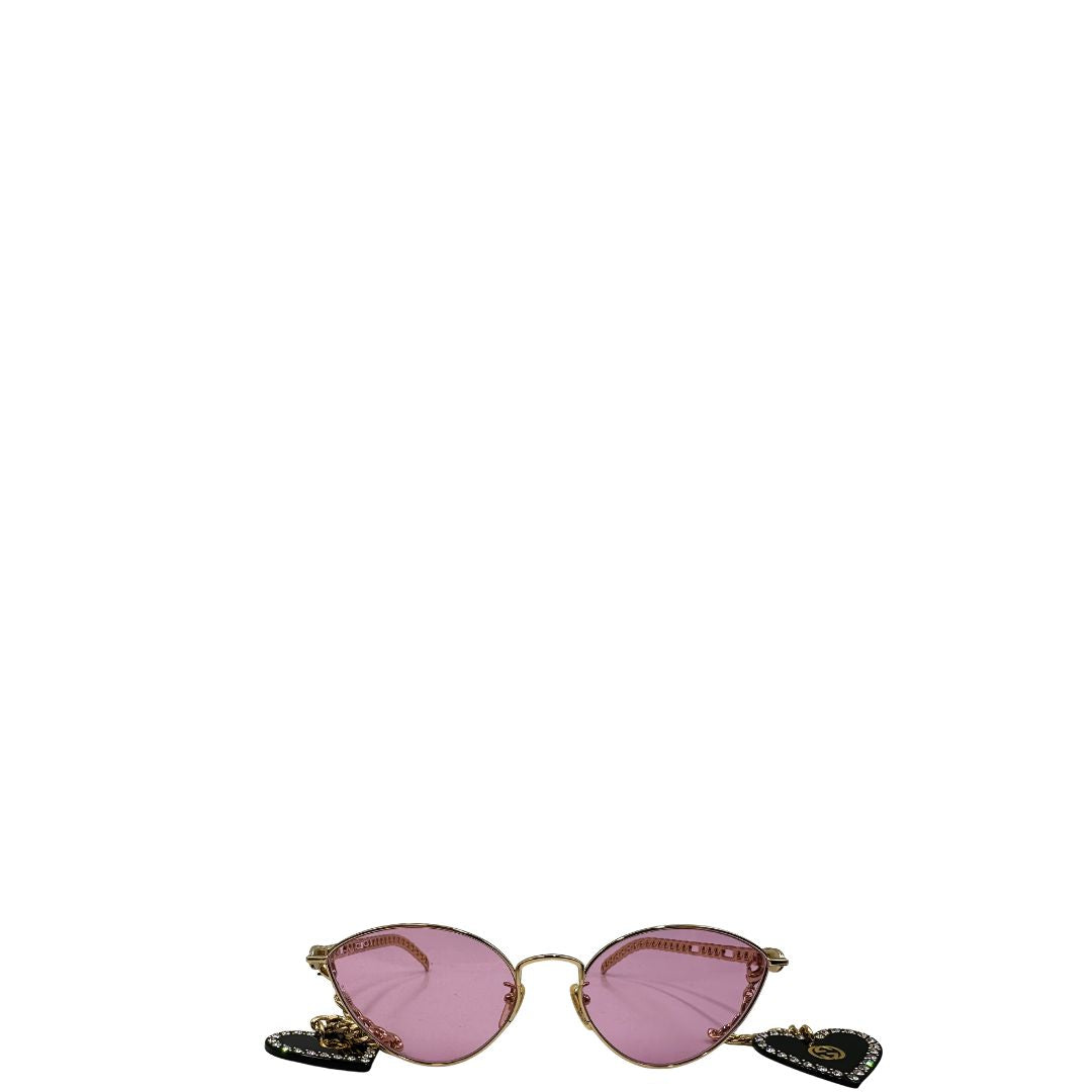 front Occhiali da sole Gucci in metallo dorato e lenti rosa, muniti di due pendenti con cuore amovibili. Completi di sacchetto antipolvere, di lusso, originale, ottime condizioni. 