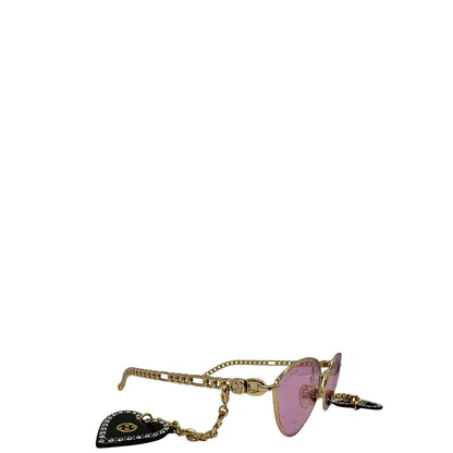 lato Occhiali da sole Gucci in metallo dorato e lenti rosa, muniti di due pendenti con cuore amovibili. Completi di sacchetto antipolvere, di lusso, originale, ottime condizioni. 