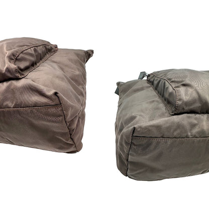 angoli Borsa Prada in nylon marrone scuro con parti metalliche argentate , munita di doppi manici in tessuto, indossabile a spalla.