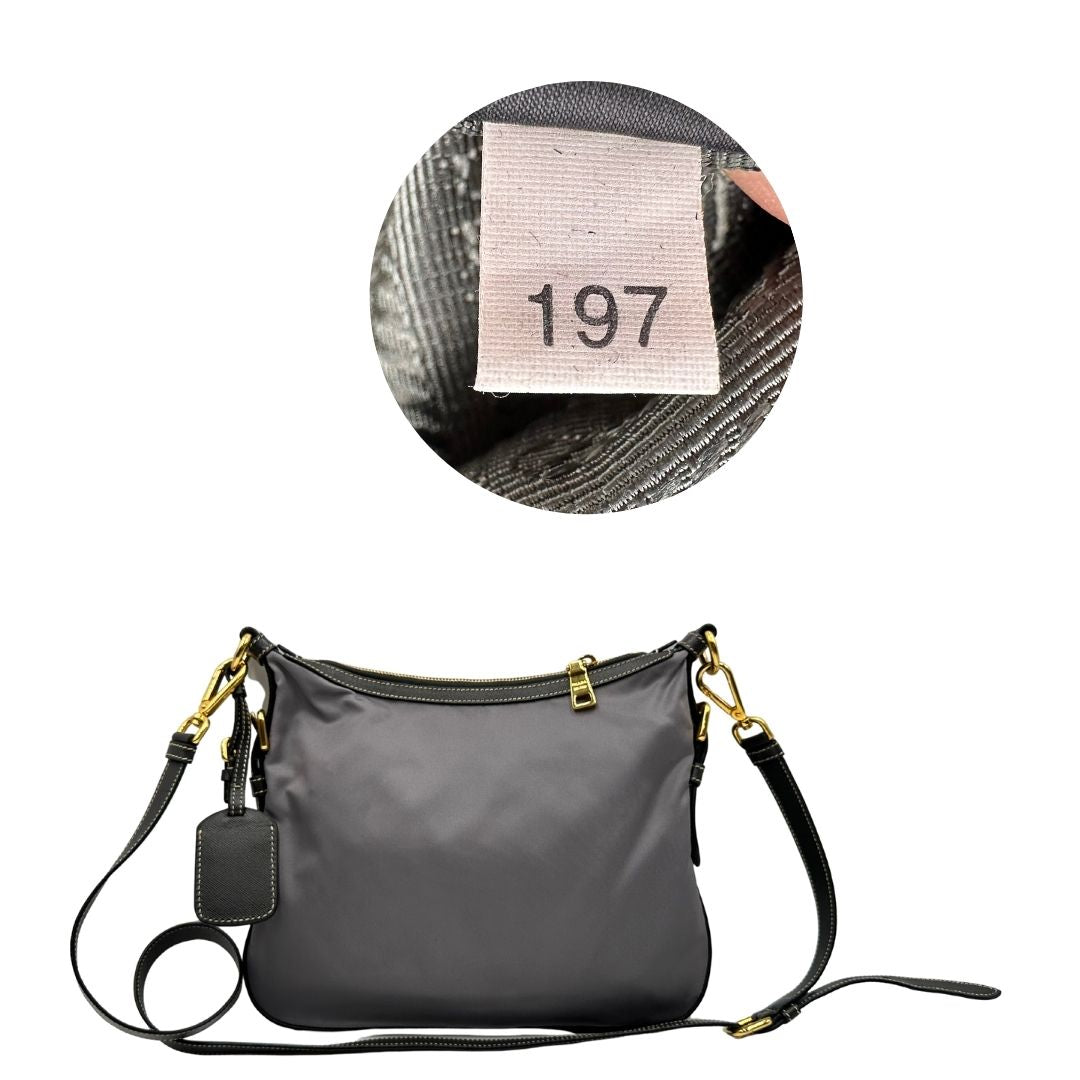 Retro di una Borsa Prada in nylon Grigia con finiture in pelle nera e parti metalliche dorate; munita di una tracolla in tessuto regolabile e tag porta address. Originale, usata, di lusso in ottime condizioni.
