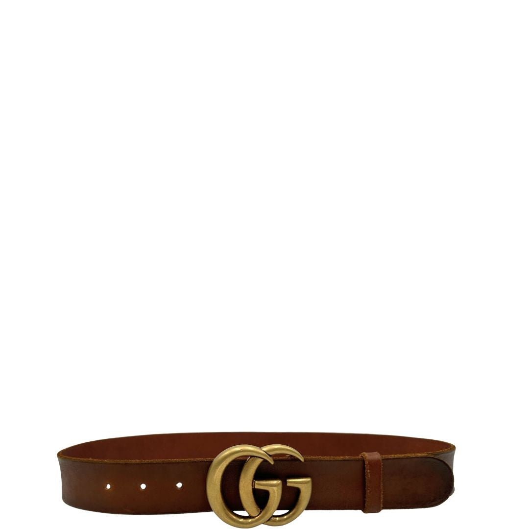 Cintura Gucci in pelle marrone bruciato, fibbia GG in metallo dorato. Completa di dustbag. Originale, usato, di lusso, in ottime condizioni.