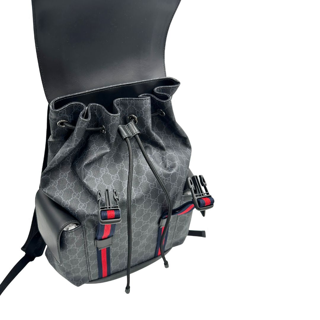 Chiusura di un Zaino Gucci in canvas grigio GG con finiture in pelle neri e parti metalliche argentate. Iconica striscia Web in blu/rosso sul front, munito di un manico singolo, Bretelle imbottite regolabili e patta con moschettoni a scatto. Completo di dustbag. Originale, usato, di lusso, in condizioni eccellenti.