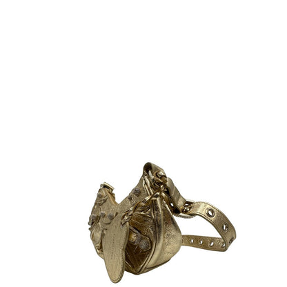 lato Borsa Balenciaga in pelle dorata con parti metalliche dorate, impreziosita da borchie con cristalli incastonati; munita di una tracolla regolabile. Completa di dustbag, di lusso, originale, ottime condizioni. 