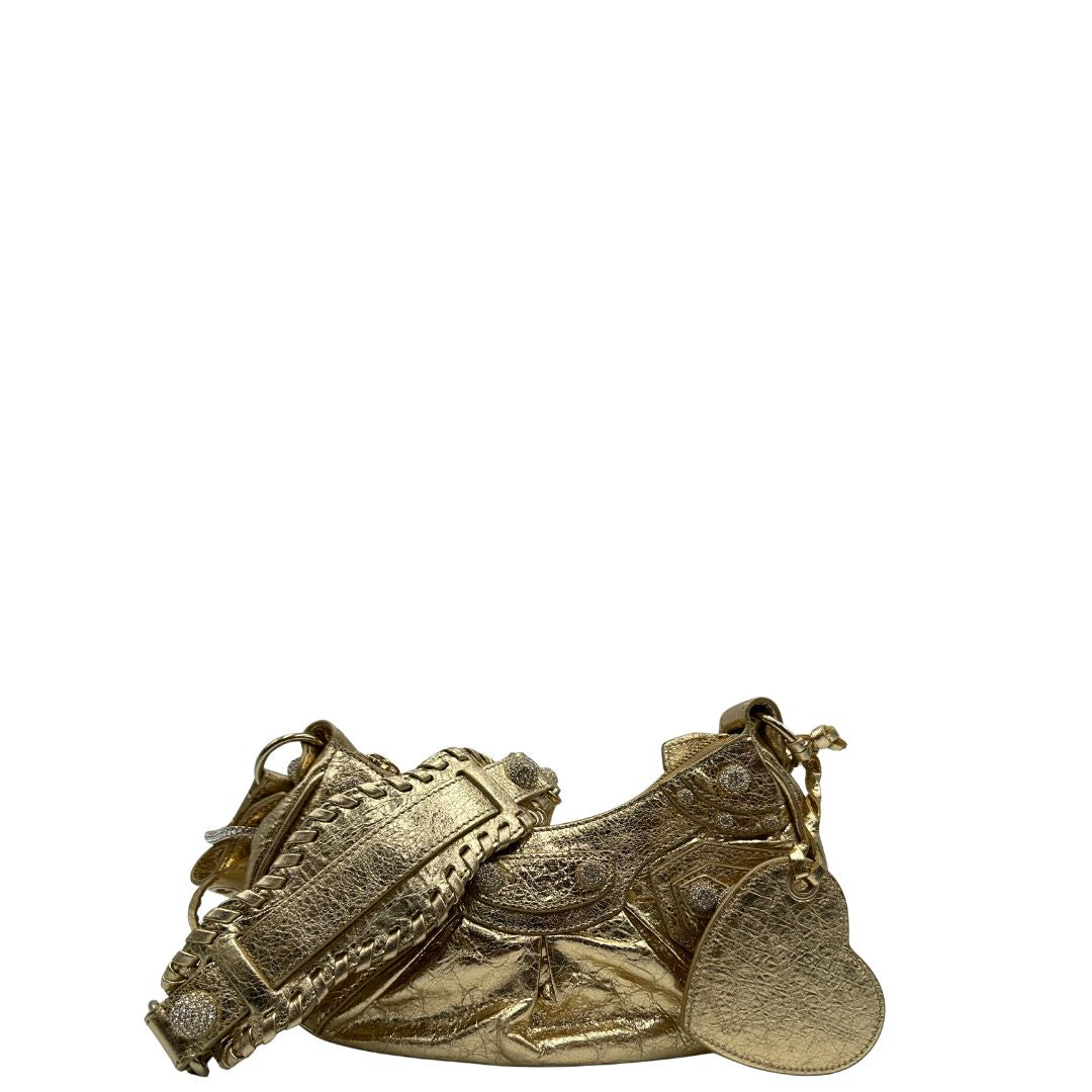 front Borsa Balenciaga in pelle dorata con parti metalliche dorate, impreziosita da borchie con cristalli incastonati; munita di una tracolla regolabile. Completa di dustbag, di lusso, originale, ottime condizioni. 