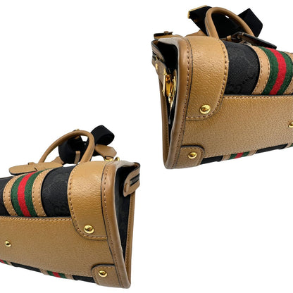 angoli Borsa Gucci in tessuto GG nera con finiture in pelle marroni, dettagli Web verdi e rossi e parti metalliche dorate; munita di doppi manici stondati e una tracolla in tessuto amovibile e regolabile. Completo di dustbag, lucchetto e chiavi, di lusso, usata, originale. 