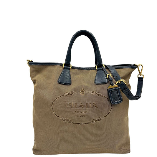 front  Borsa Prada in tessuto color corda con logo Jacquard sul front, finiture in pelle blu e parti metalliche dorate; munita di doppi manici e una tracolla amovibile e regolabile. Completa di dustbag, ottime condizioni, usata. 