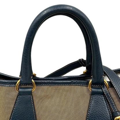 manici  Borsa Prada in tessuto color corda con logo Jacquard sul front, finiture in pelle blu e parti metalliche dorate; munita di doppi manici e una tracolla amovibile e regolabile. Completa di dustbag, ottime condizioni, usata. 