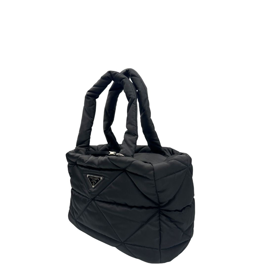 Lato sinistro di un Trasaportino Prada in tessuto nylon imbottito nero con parti metalliche argentate; munito di doppie manici. Da portare a mano. Originale, usato, di lusso, in condizioni eccellenti.