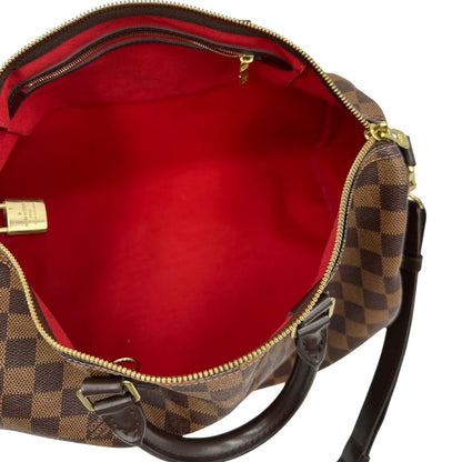 interno Borsa Speedy 35 in canvas Damier Ébène marrone con finiture in pelle marrone e parti metalliche dorate; munita di una tracolla amovibile e regolabile e doppi manici stondati. Completa di scatola, lucchetto e chiavi, di lusso, originale, usata.