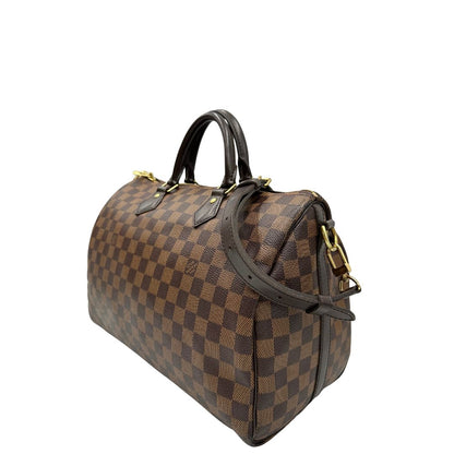 lato Borsa Speedy 35 in canvas Damier Ébène marrone con finiture in pelle marrone e parti metalliche dorate; munita di una tracolla amovibile e regolabile e doppi manici stondati. Completa di scatola, lucchetto e chiavi, di lusso, originale, usata. 