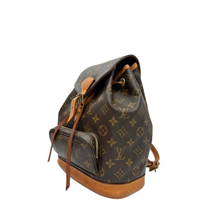 lato Zaino Montsouris mini in canvas marrone monogram con finiture in vacchetta naturale e parti metalliche dorate, munito di un anello sulla parte superiore e due bretelle in vacchetta regolabili con fibbie, di lusso, originale, ottime condizioni. 