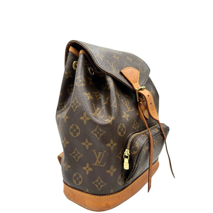 lato Zaino Montsouris mini in canvas marrone monogram con finiture in vacchetta naturale e parti metalliche dorate, munito di un anello sulla parte superiore e due bretelle in vacchetta regolabili con fibbie, di lusso, originale, ottime condizioni. 