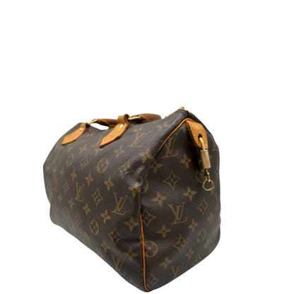 lato Borsa Louis Vuitton in canvas marrone monogram con finiture in vacchetta naturale e parti metalliche dorate; munita di doppi manici stondati. Completa di dustbag, lucchetto e chiavi, di lusso, originale, ottime condizioni. 