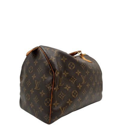 lato Borsa Louis Vuitton in canvas marrone monogram con finiture in vacchetta naturale e parti metalliche dorate; munita di doppi manici stondati. Completa di dustbag, lucchetto e chiavi, di lusso, originale, ottime condizioni. 