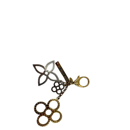 Charm Louis Vuitton in metallo argentato e dorato con iconica forma del classico fiore della maison. Full set, di lusso, originale, usato.