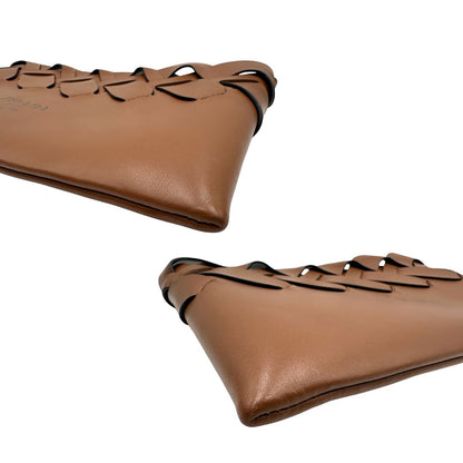 Angoli di una Pochette Prada in pelle marrone cognac con parti metalliche argentate, presenta un motivo intrecciato nella parte superiore, munita di una pochette estraibile in pelle nera con logo lettering sul front. Originale, usata, di lusso, in ottime condizioni.